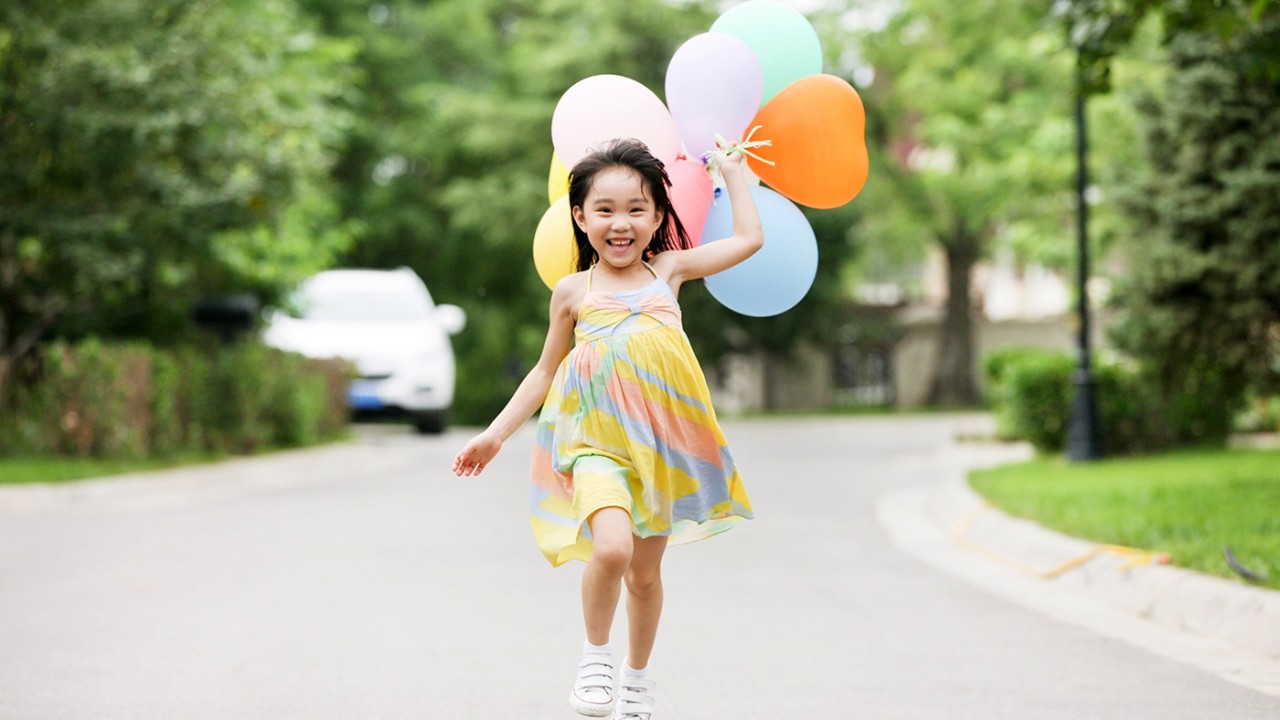 Girl running with balloons; image used for HSBC Philippines Card Balance Conversion Plan