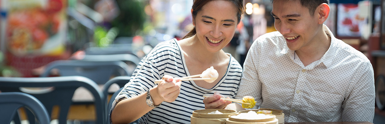 Happy couple eating dim sum; image used for HSBC Philippines Credit Card Offers Red Hot Deals page