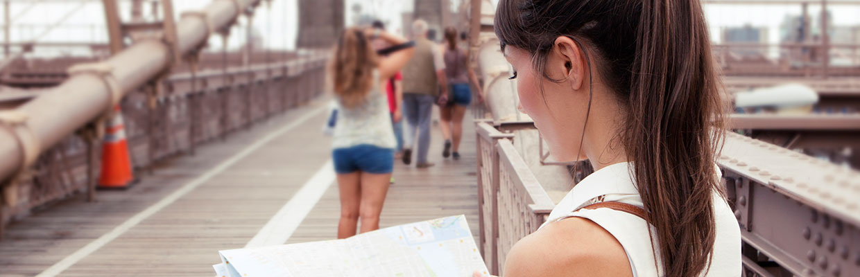 A female tourist looking at the map; image used for HSBC Philippines Credit Card offers Cathay Pacific page